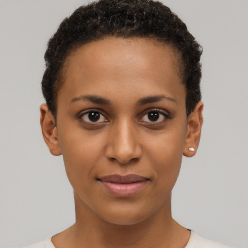 Joyful black young-adult female with short  brown hair and brown eyes