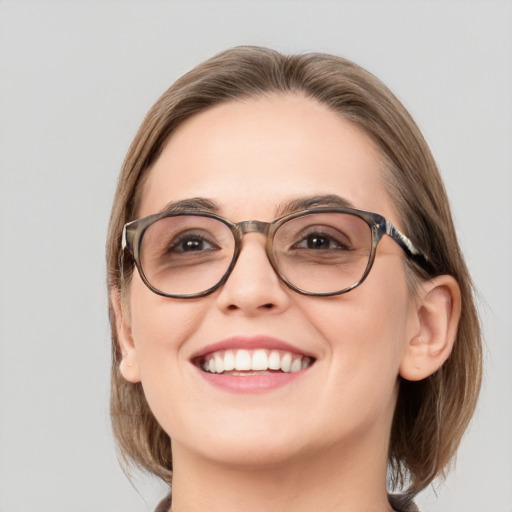 Joyful white adult female with medium  brown hair and blue eyes