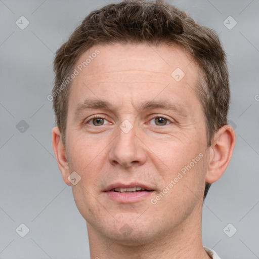 Joyful white adult male with short  brown hair and grey eyes