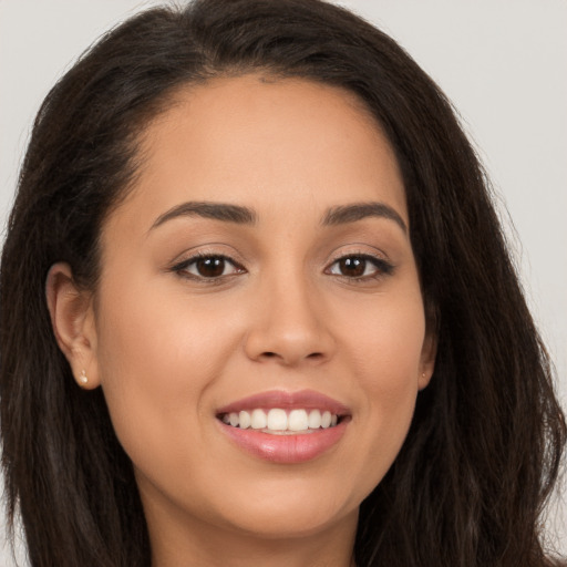 Joyful white young-adult female with long  brown hair and brown eyes