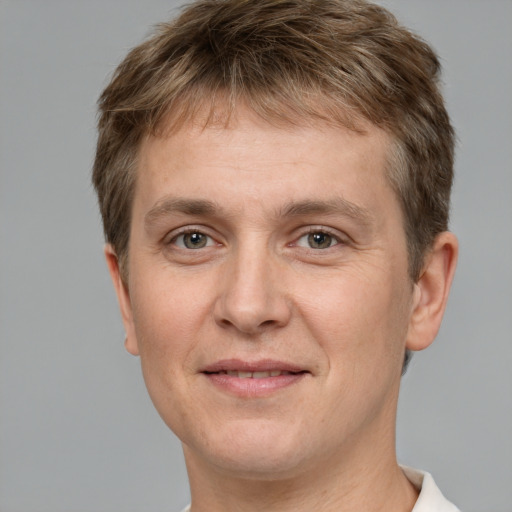 Joyful white adult male with short  brown hair and grey eyes