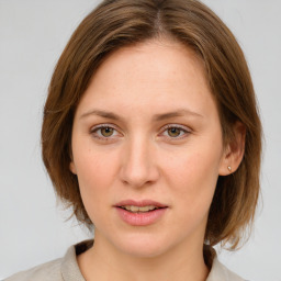 Joyful white young-adult female with medium  brown hair and green eyes