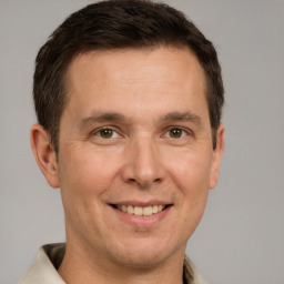 Joyful white adult male with short  brown hair and brown eyes