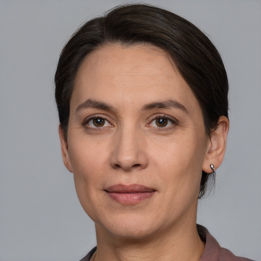 Joyful white adult female with short  brown hair and grey eyes