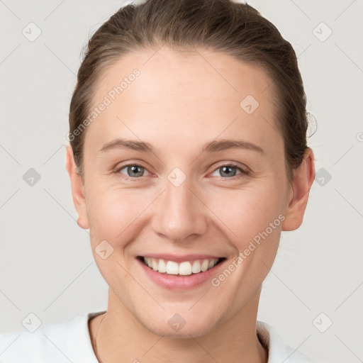 Joyful white young-adult female with short  brown hair and grey eyes