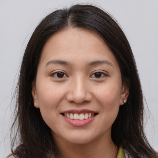 Joyful white young-adult female with long  brown hair and brown eyes