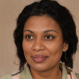 Joyful black adult female with medium  brown hair and brown eyes