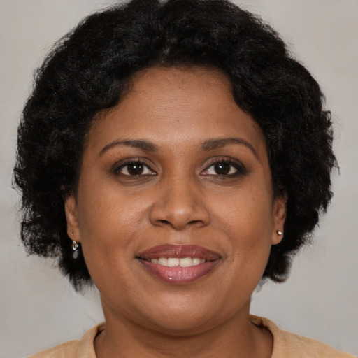 Joyful black young-adult female with medium  brown hair and brown eyes