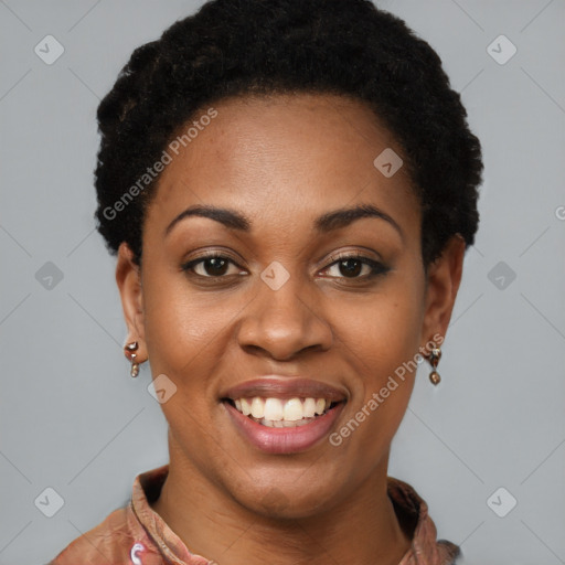 Joyful black young-adult female with short  black hair and brown eyes