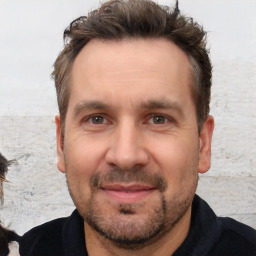 Joyful white adult male with short  brown hair and brown eyes