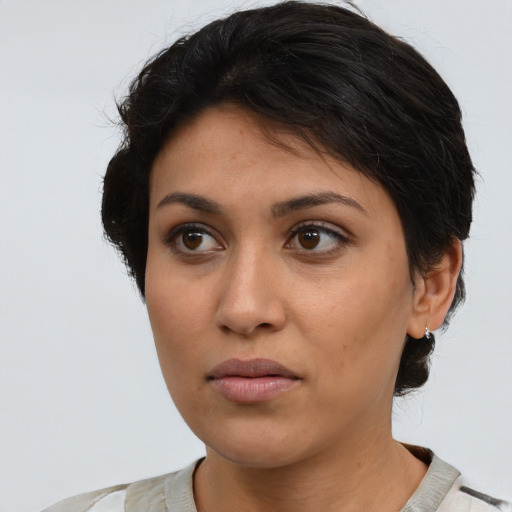 Neutral latino young-adult female with medium  brown hair and brown eyes