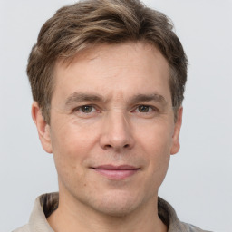 Joyful white adult male with short  brown hair and grey eyes