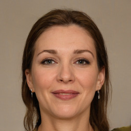 Joyful white adult female with medium  brown hair and grey eyes