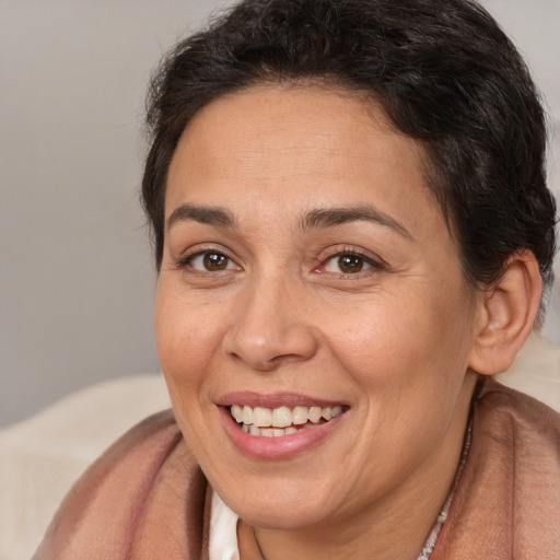Joyful white adult female with short  brown hair and brown eyes
