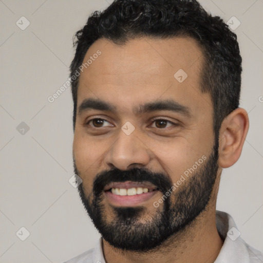 Joyful latino young-adult male with short  black hair and brown eyes