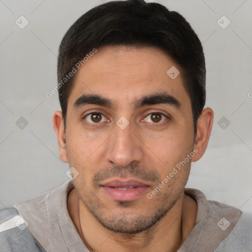 Joyful white young-adult male with short  black hair and brown eyes