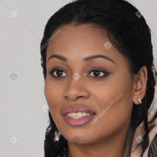 Joyful black young-adult female with long  black hair and brown eyes