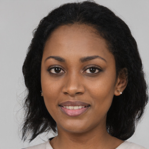 Joyful black young-adult female with medium  black hair and brown eyes