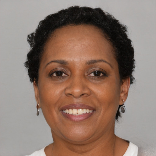 Joyful black adult female with short  brown hair and brown eyes