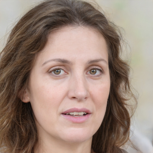 Joyful white young-adult female with medium  brown hair and green eyes