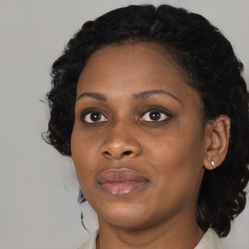 Joyful black adult female with medium  black hair and brown eyes