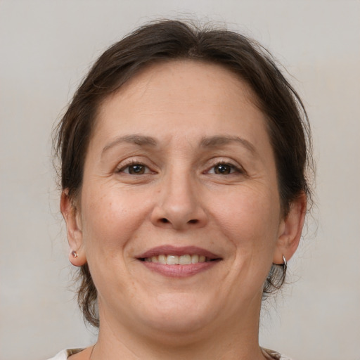 Joyful white adult female with medium  brown hair and brown eyes