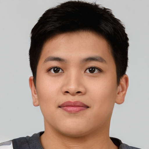 Joyful asian young-adult male with short  black hair and brown eyes