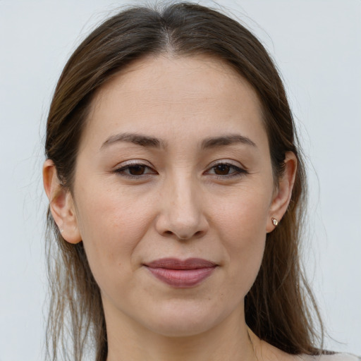 Joyful white young-adult female with long  brown hair and grey eyes