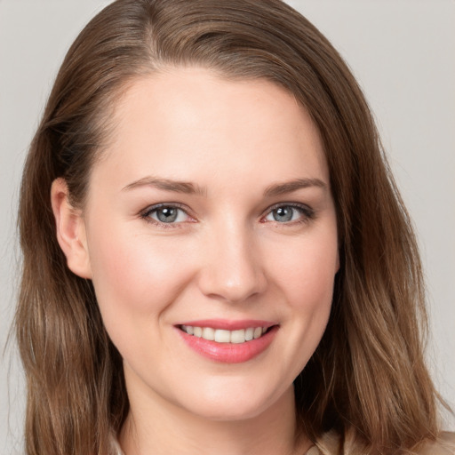 Joyful white young-adult female with long  brown hair and grey eyes