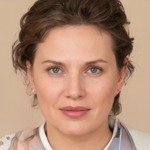 Joyful white young-adult female with medium  brown hair and blue eyes