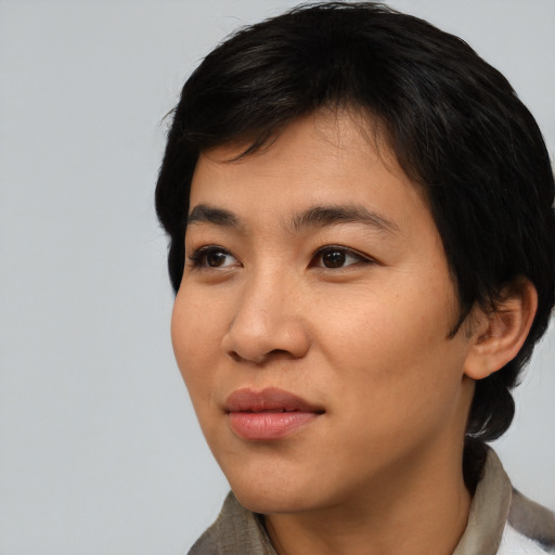 Joyful asian young-adult female with short  black hair and brown eyes