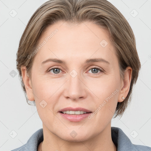 Joyful white adult female with medium  brown hair and grey eyes