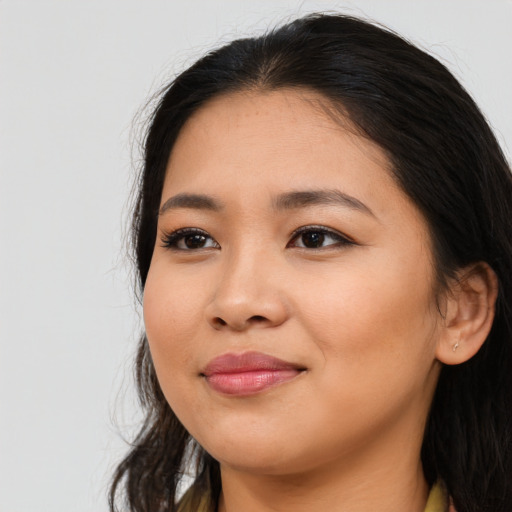 Joyful asian young-adult female with long  black hair and brown eyes