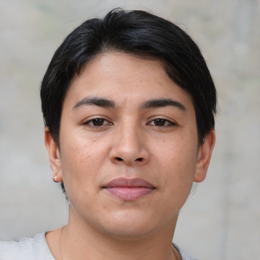 Joyful latino young-adult female with short  black hair and brown eyes