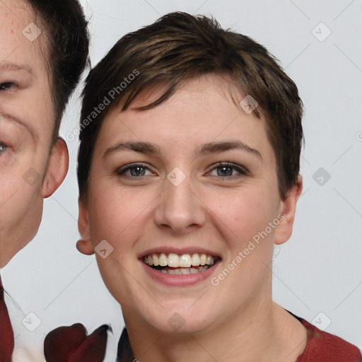 Joyful white young-adult female with short  brown hair and grey eyes