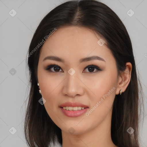 Joyful asian young-adult female with long  brown hair and brown eyes