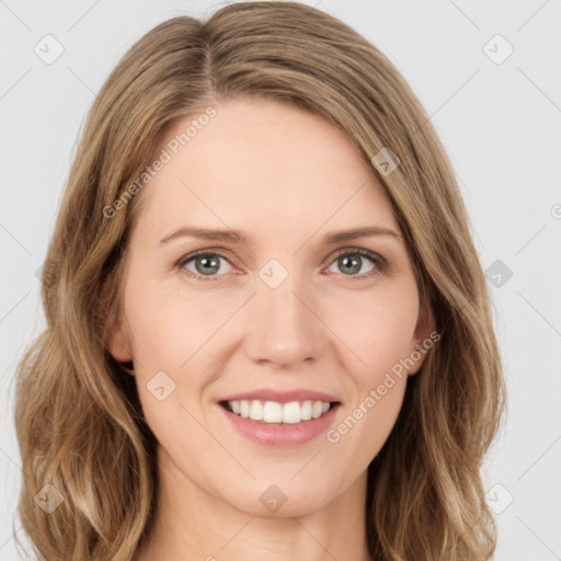 Joyful white young-adult female with long  brown hair and green eyes