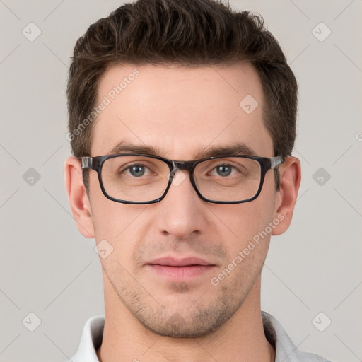 Joyful white young-adult male with short  brown hair and grey eyes