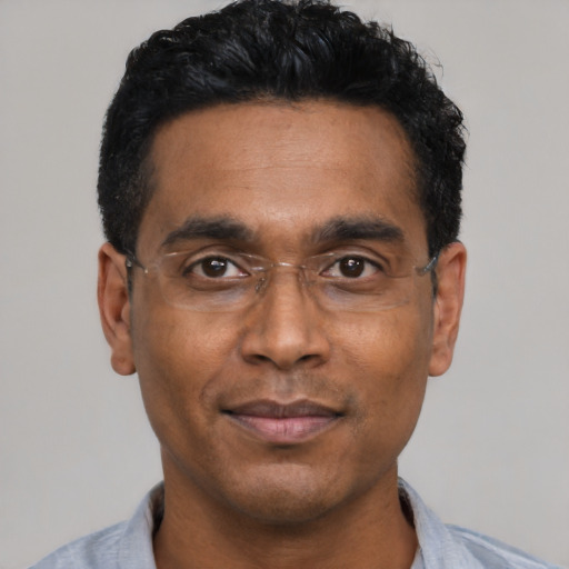 Joyful black adult male with short  black hair and brown eyes