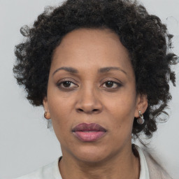 Joyful black adult female with short  brown hair and brown eyes