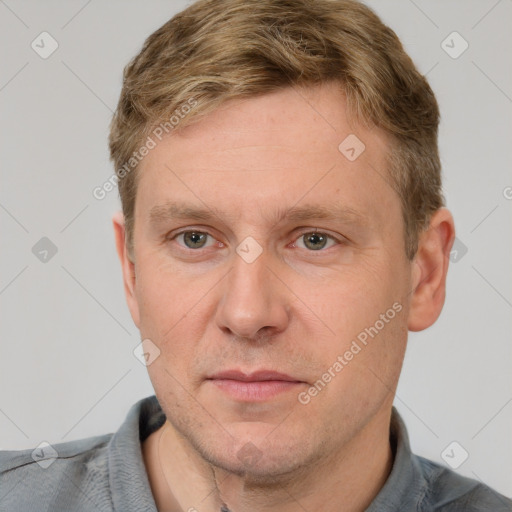 Joyful white adult male with short  brown hair and grey eyes