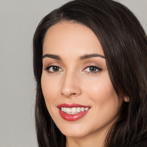 Joyful white young-adult female with long  black hair and brown eyes