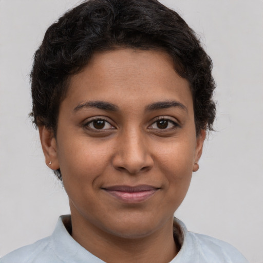 Joyful latino young-adult female with short  brown hair and brown eyes