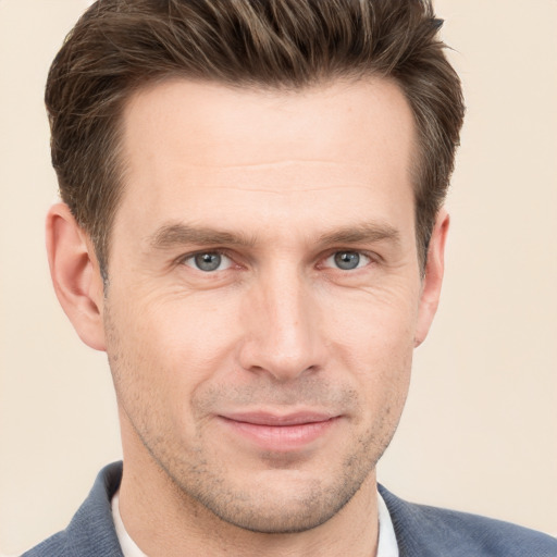 Joyful white adult male with short  brown hair and grey eyes