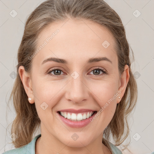 Joyful white young-adult female with medium  brown hair and grey eyes