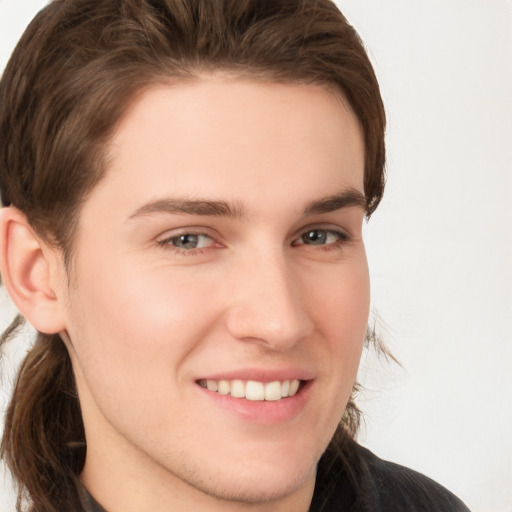 Joyful white young-adult male with medium  brown hair and brown eyes