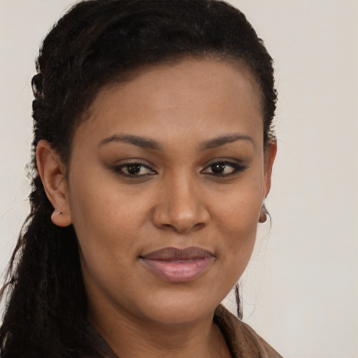 Joyful black young-adult female with long  brown hair and brown eyes