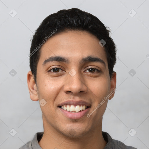 Joyful latino young-adult male with short  black hair and brown eyes