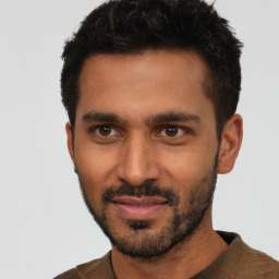 Joyful white young-adult male with short  black hair and brown eyes