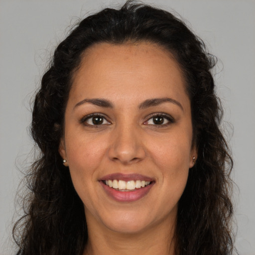 Joyful white adult female with long  brown hair and brown eyes